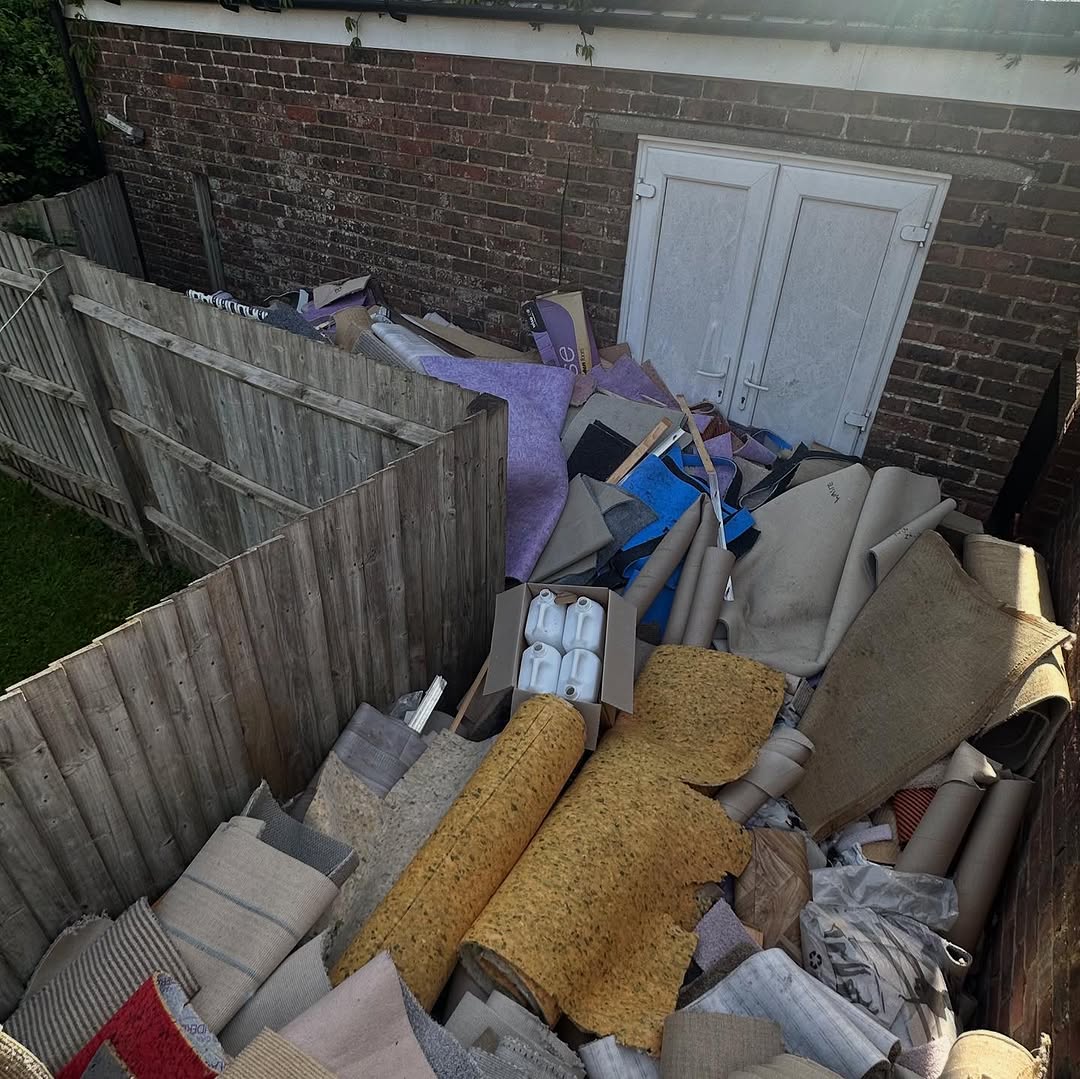 Large pile of household waste and carpet before clearance