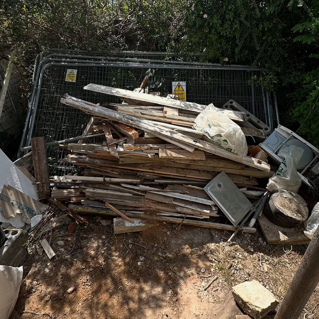 Construction timber waste pile ready for clearance at a Sussex building site